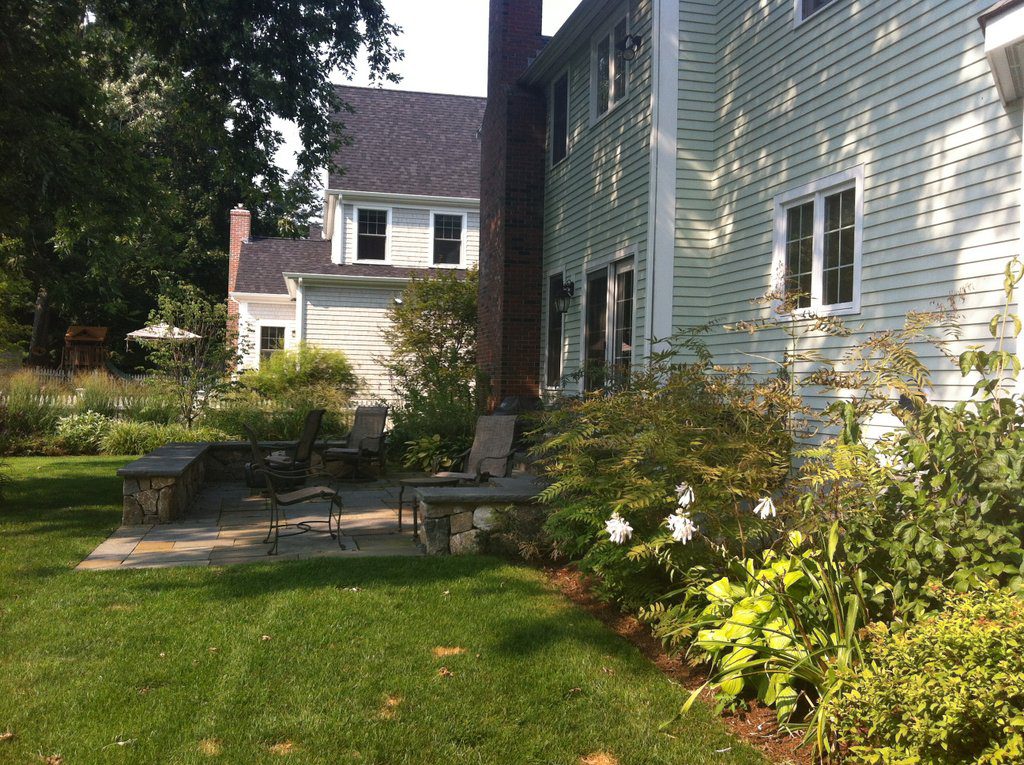 Patio replaces deck and bulkhead screened by plant material